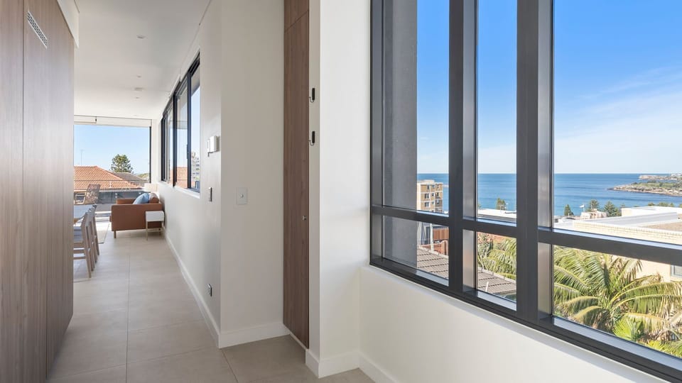 A wide hallway enhances the home's spacious and open feel.