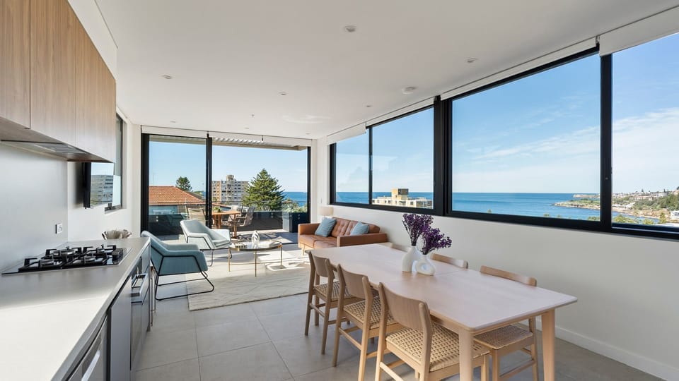 The open-plan dining area lets you enjoy every meal with a spectacular coastal backdrop.