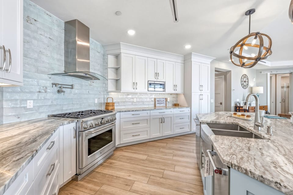 The gourmet kitchen features premium appliances, abundant counter space, and custom cabinetry.