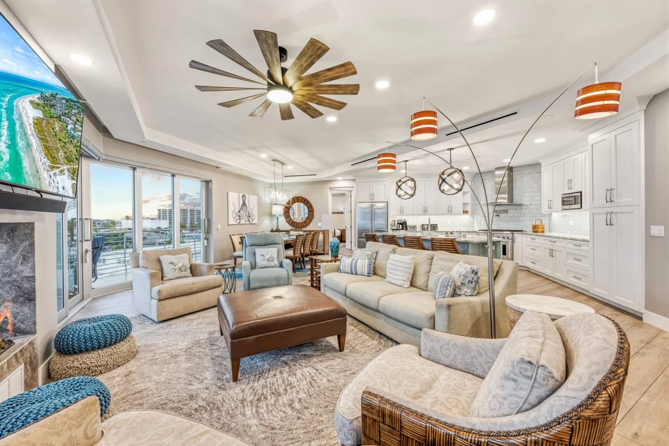 Plush seating, a mounted TV, and expansive windows create the perfect place to gather.