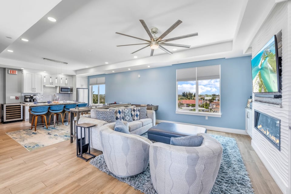 The open-concept living area brings everyone together with comfortable seating, a fireplace, and easy access to the kitchen.