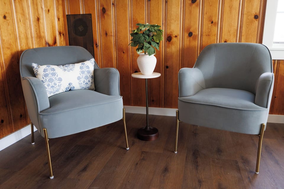 Slip into the reading corner while everyone else is out on the water — daylight pouring in, cove in your peripheral, nothing demanding attention.