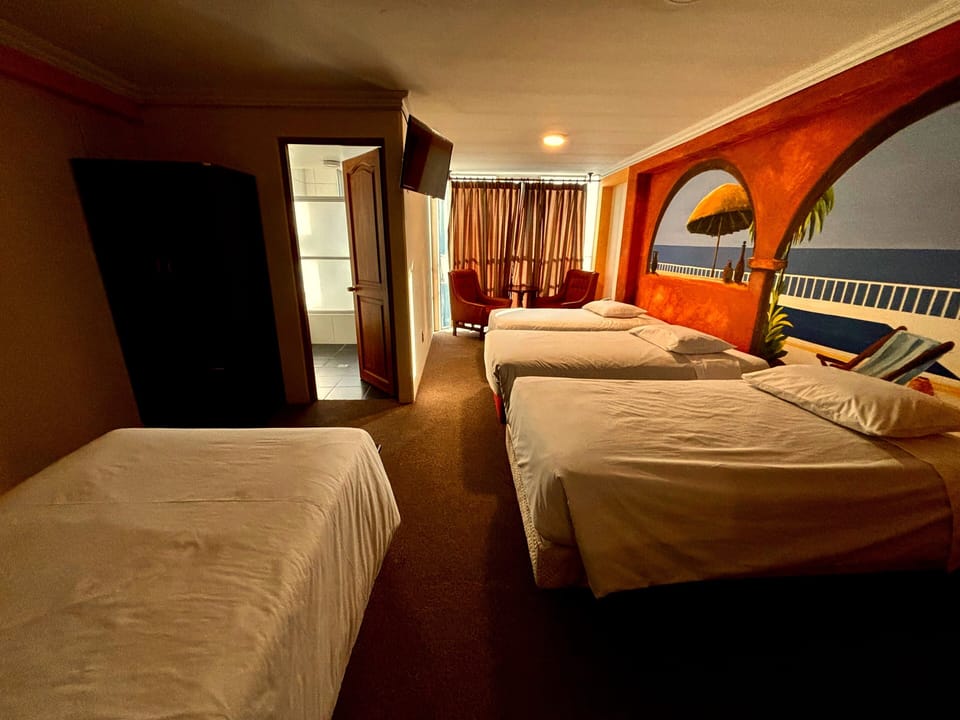 Quadruple Room, City View | Desk, laptop workspace, WiFi (free), bed sheets