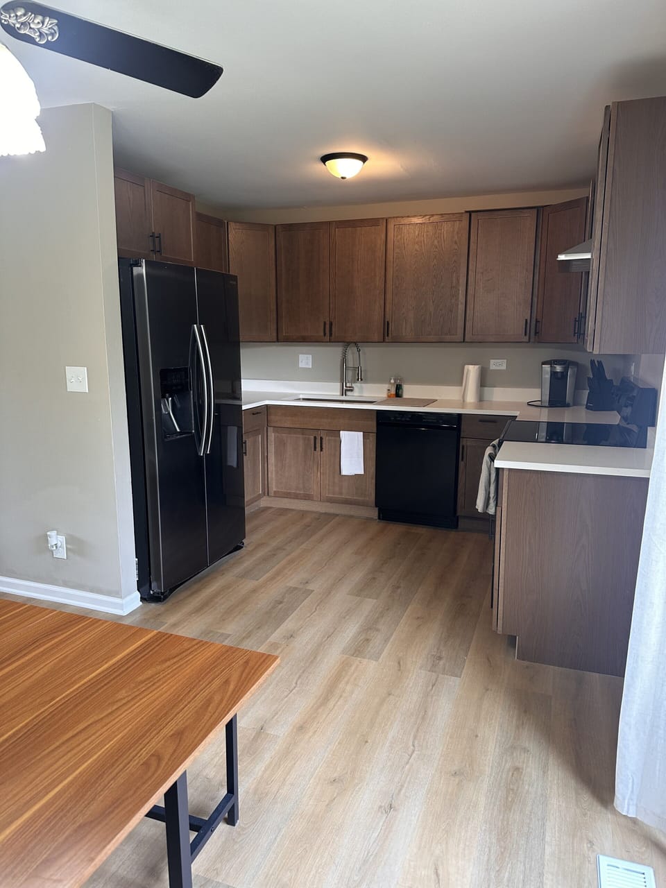 Compact studio with kitchenette, wood floors, and handy dining space