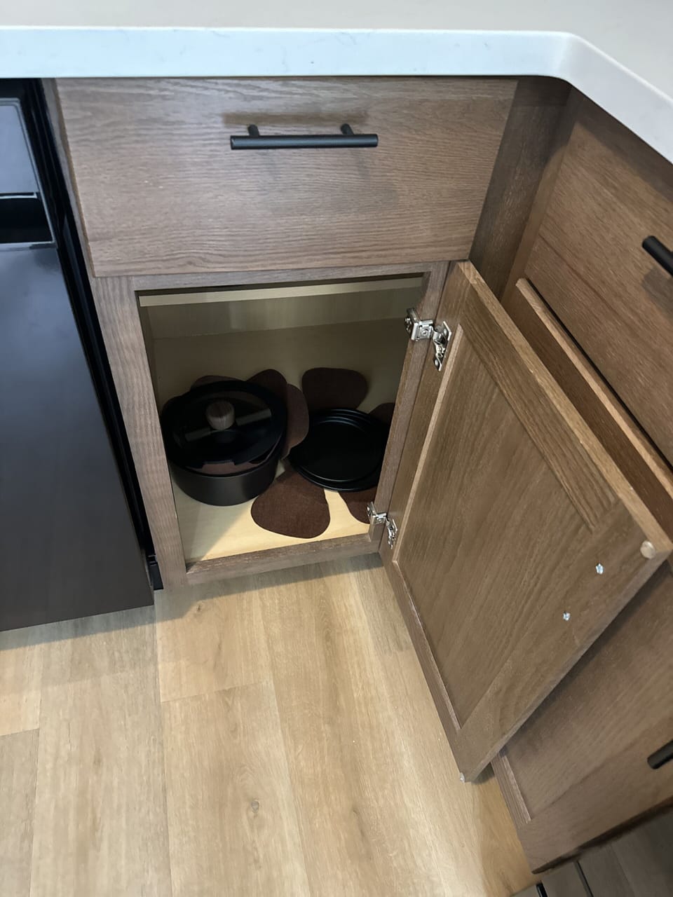 Modern kitchen storage with cookware and sleek wood cabinetry