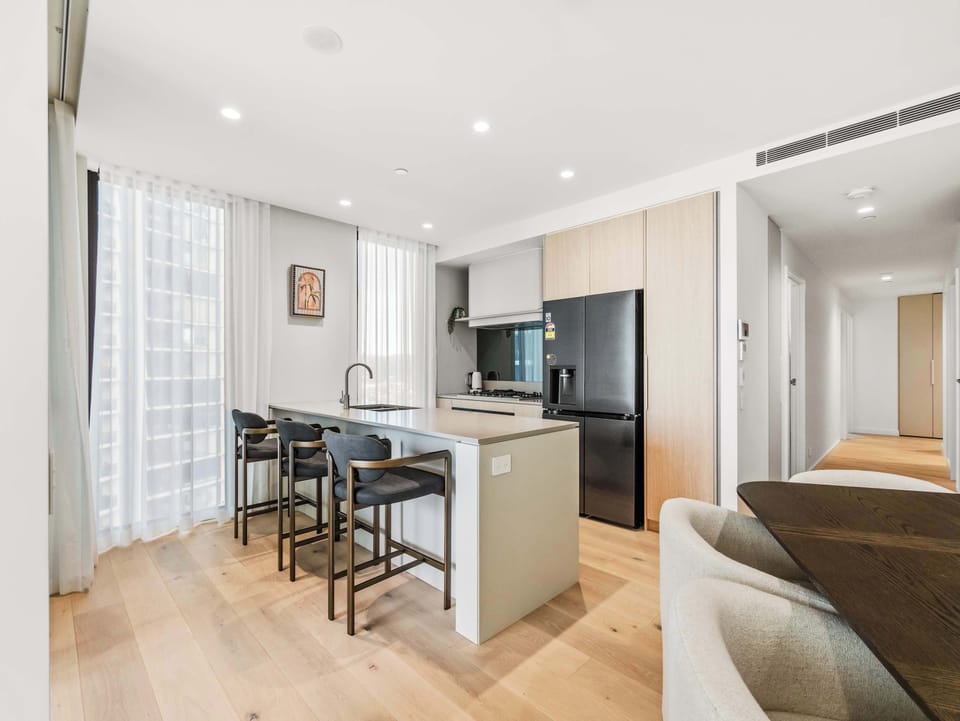 The kitchen sits between the dining table and the hallway.
