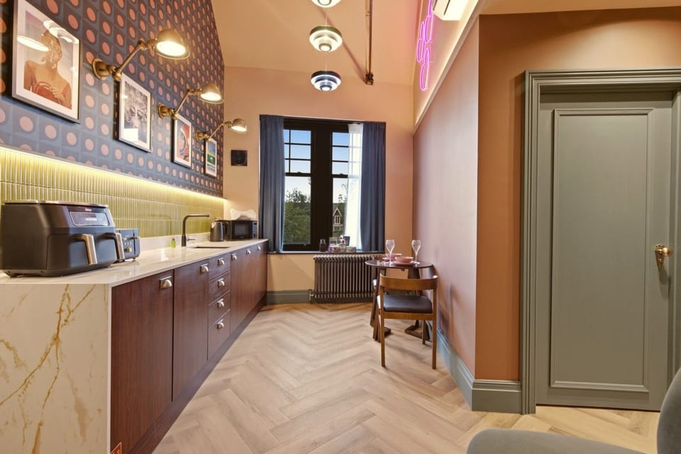 Double bedroom with wood-panelled headboard and warm bedside lighting