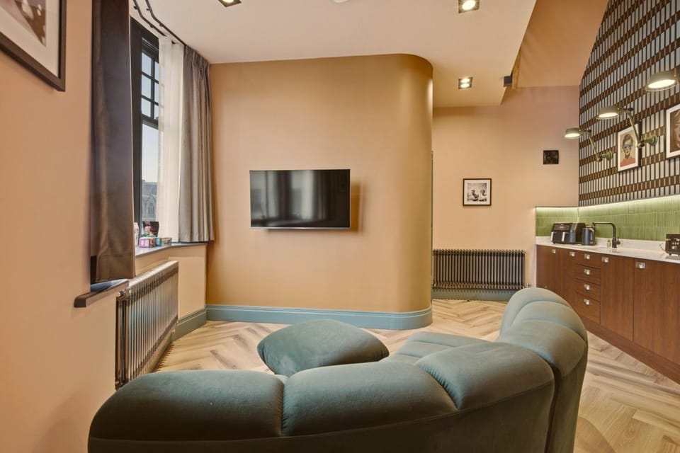 Mezzanine bedroom with double bed, exposed beams and bedside lamps