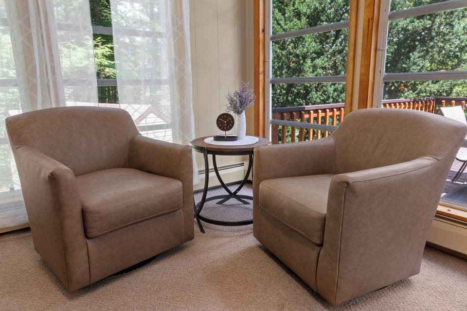 Bright reading nook with forest views and cozy lounge seating