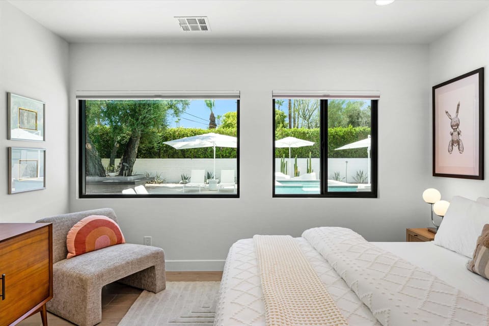 King bedroom overlooking the pool and shaded patio