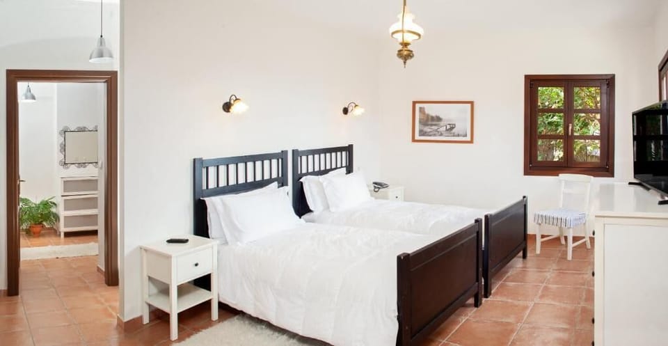 Relax in a beautifully appointed master bedroom featuring a plush double bed, abundant natural light, and a serene atmosphere designed for restful nights.