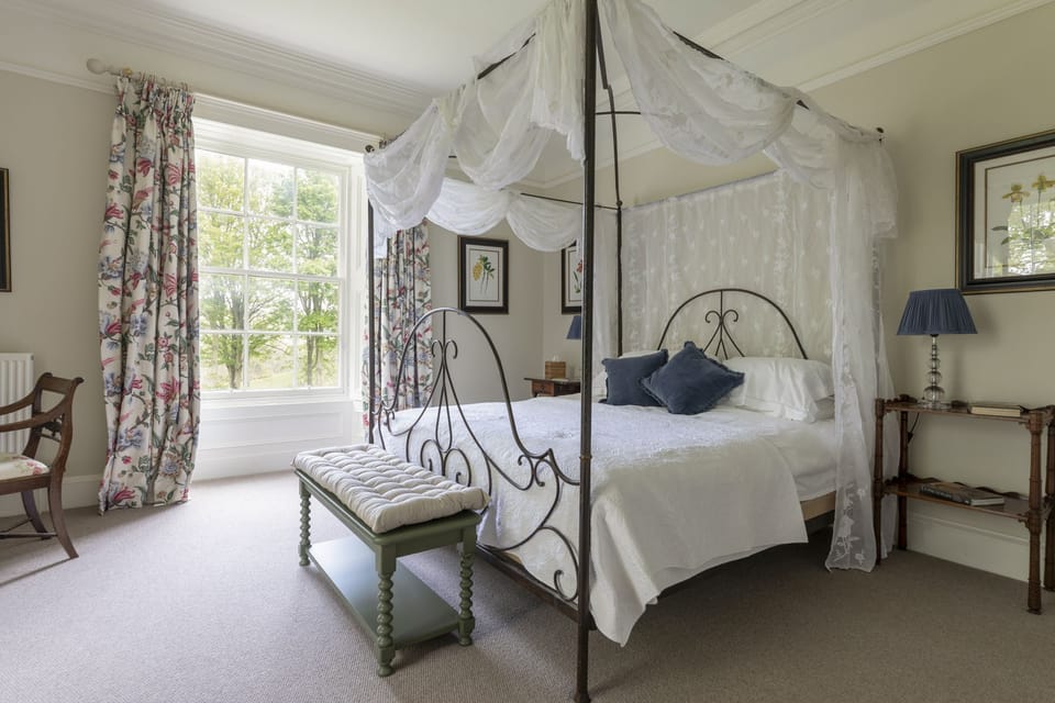 Sunderland Farmhouse - bedroom one with super king four poster bed