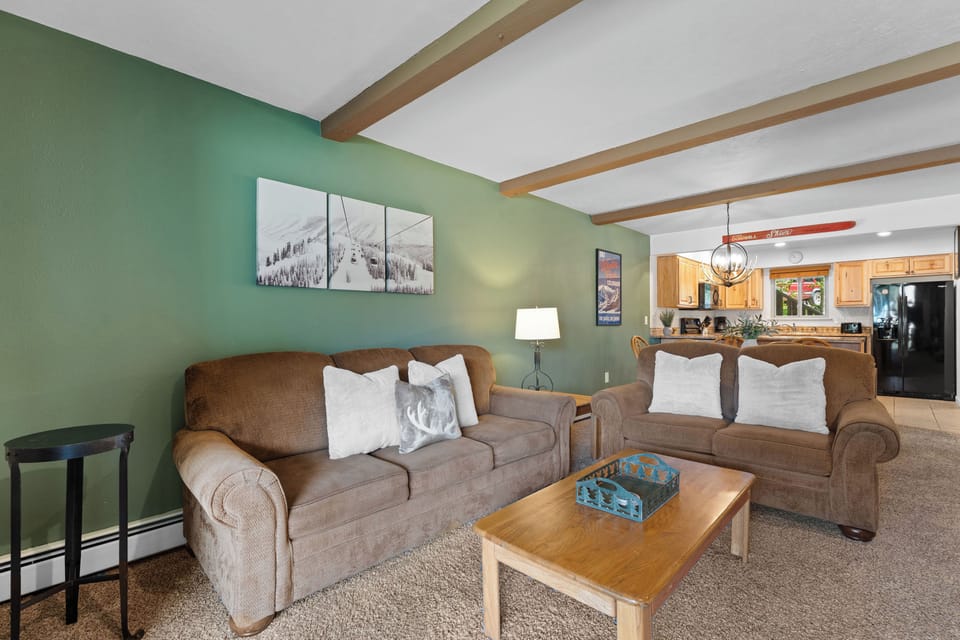 Sink into plush sofas with mountain-inspired décor and warm wood accents. The open layout connects you to the kitchen, perfect for gathering and unwinding after your adventures.