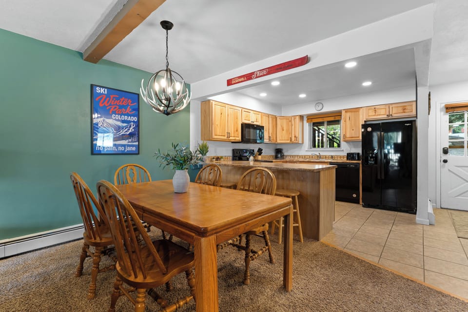 Gather around the welcoming dining table and fully-equipped kitchen, perfect for sharing mountain memories and home-cooked meals after your Colorado adventures.
