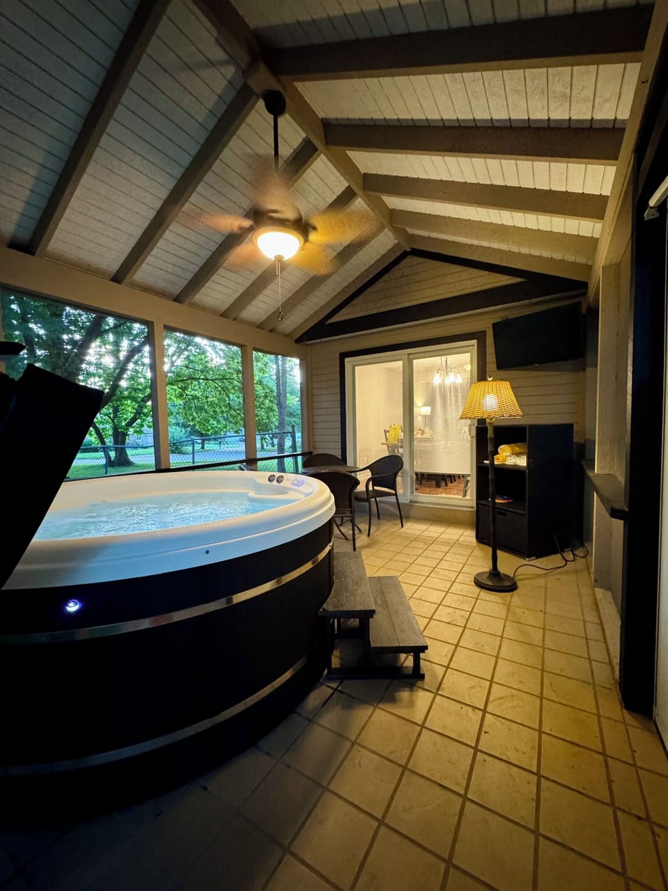 Private screened patio with hot tub and peaceful wooded views
