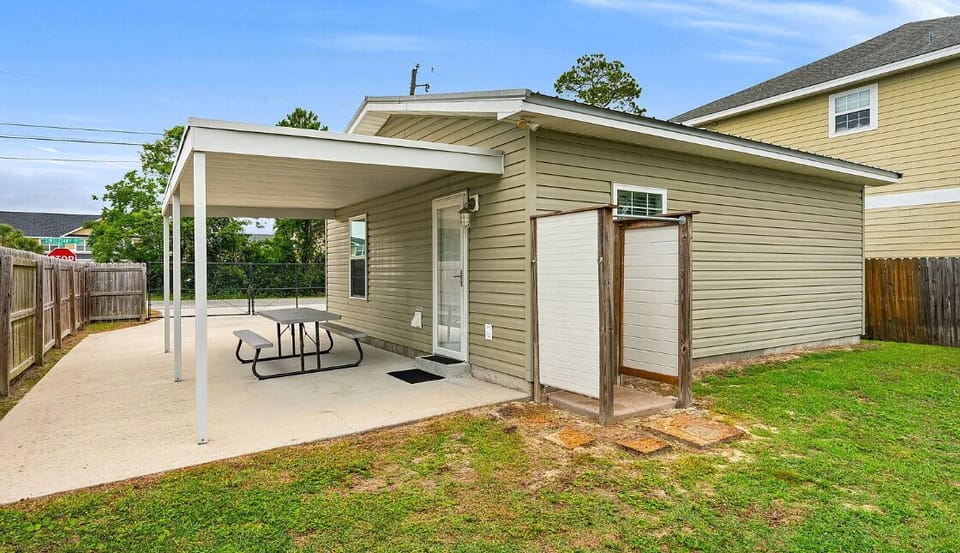 Outdoor space featuring covered parking and a private yard in a quiet residential area.