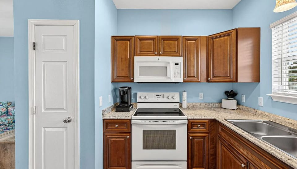 Your fully-equipped kitchen features warm wood cabinetry, granite countertops, and modern appliances—everything you need to prepare meals at your own pace during your stay.