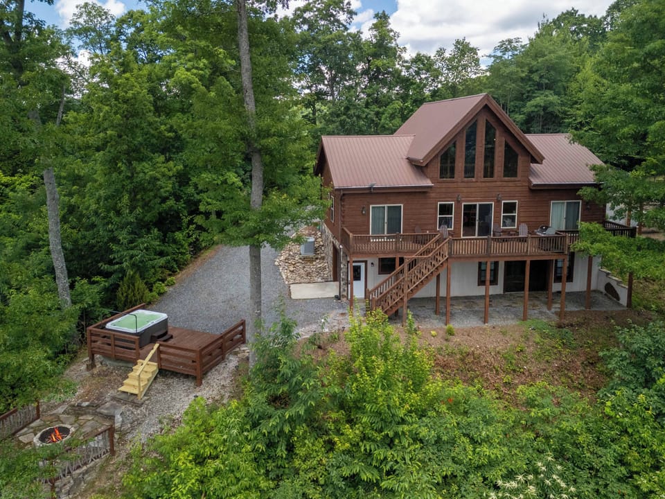 Aerial View - Aerial view of the back of the home showing back deck, hot tub deck, and fire pit area.