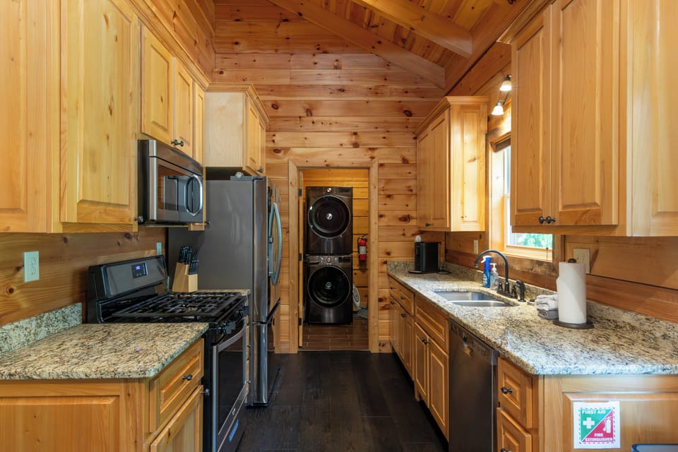Kitchen - Kitchen with gas stove, refrigerator, dishwasher, microwave. Also looking into laundry room with a stackable washer and dryer.