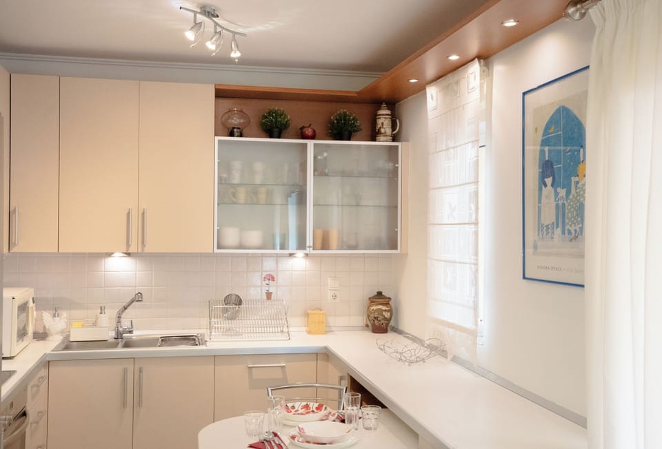 Bright, fully equipped kitchen with quality appliances, generous counter space, 