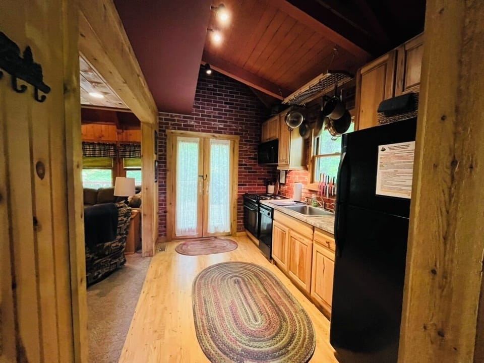 Fully equipped kitchen with a full size refrigerator and glass top stove.