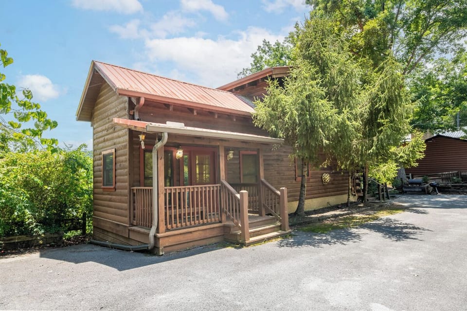 Warm knotty pine surrounds your private bathroom, complete with fresh towels and a relaxing tub-shower combo ready for your mountain getaway.