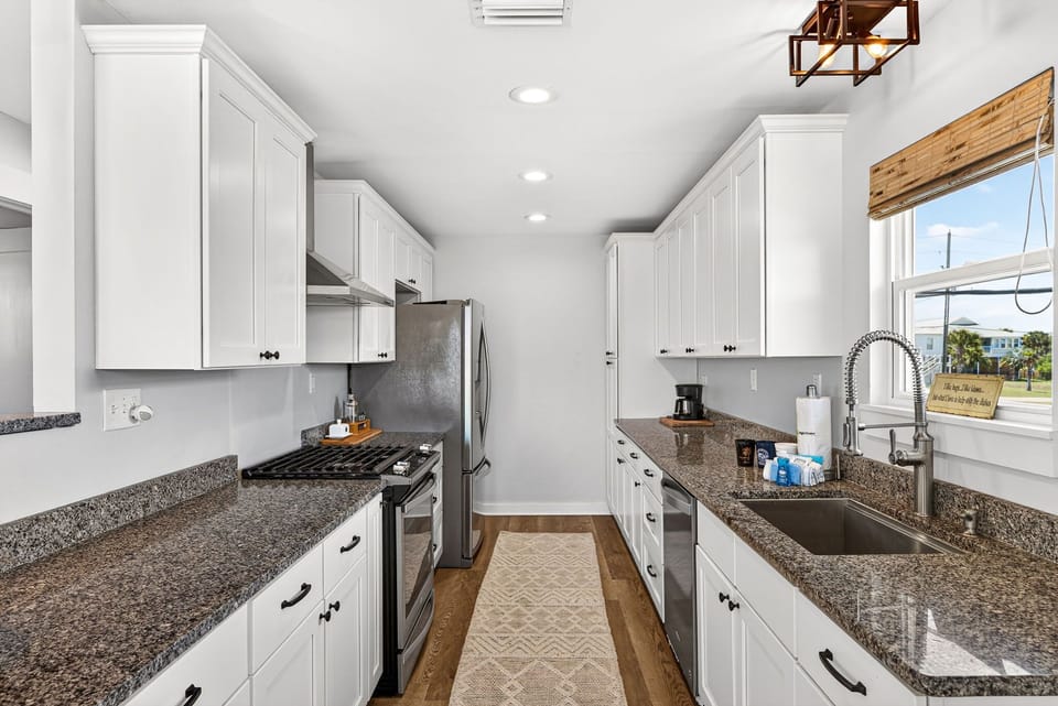 Your fully-equipped kitchen awaits with granite counters, stainless appliances, and ample space to prepare your favorite meals during your coastal getaway.
