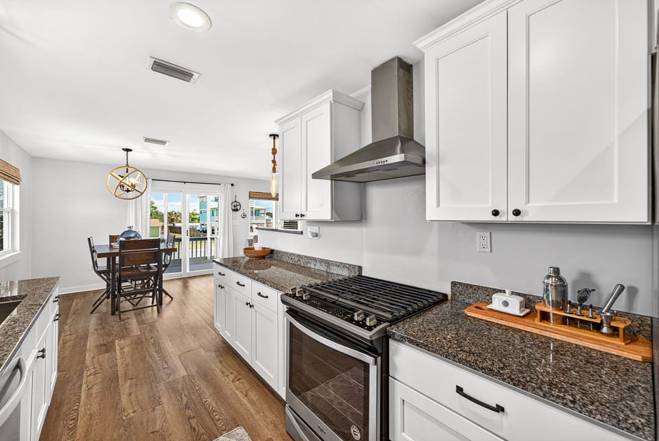 Your modern, fully-equipped kitchen awaits, complete with sleek granite countertops, stainless appliances, and ample space for preparing memorable meals together.