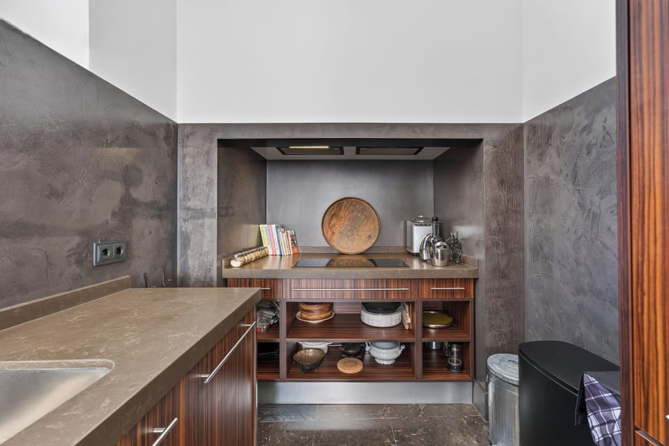Stylish modern kitchenette with stocked shelves and sleek finishes