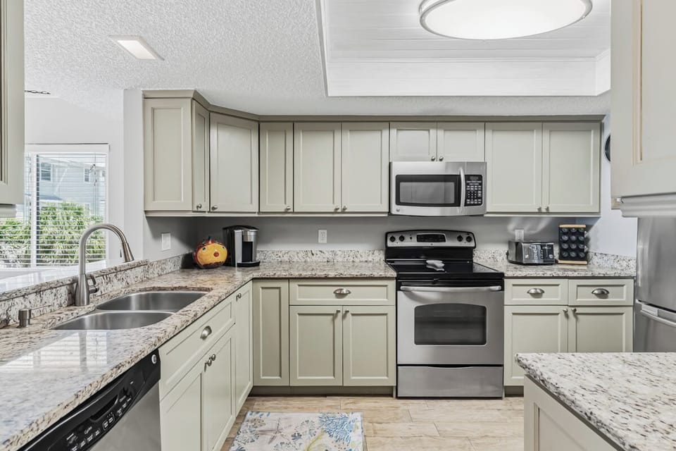 Your fully equipped kitchen awaits with granite counters, stainless steel appliances, and all the tools you need to cook your favorite meals in comfort and style.