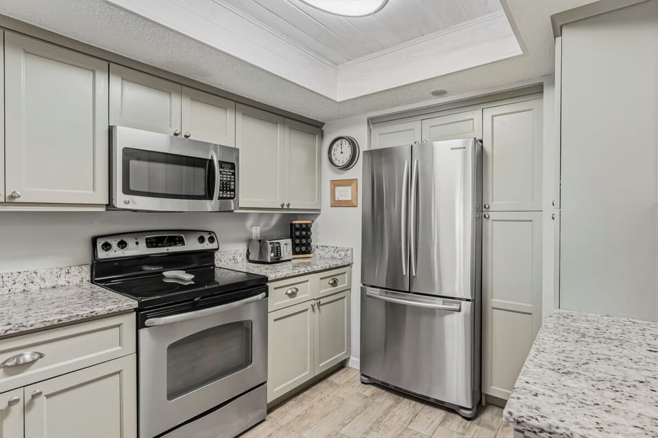 Step into your fully equipped kitchen, complete with modern stainless-steel appliances, granite countertops, and all the essentials you'll need to whip up meals at home.