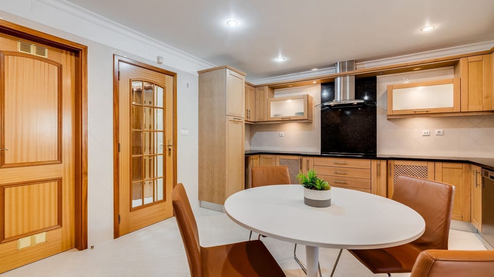 Prepare delicious meals in this well-equipped kitchen, offering everything you need for home-cooked comfort, then gather around the charming dining table for leisurely breakfasts or intimate dinners. The warm wooden cabinetry and modern appliances create 