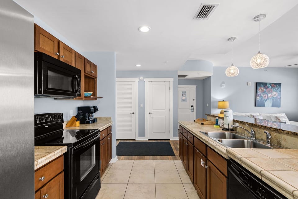 Cook comfortably in this spacious kitchen with granite countertops, modern appliances, and a bright open layout perfect for your vacation meals.