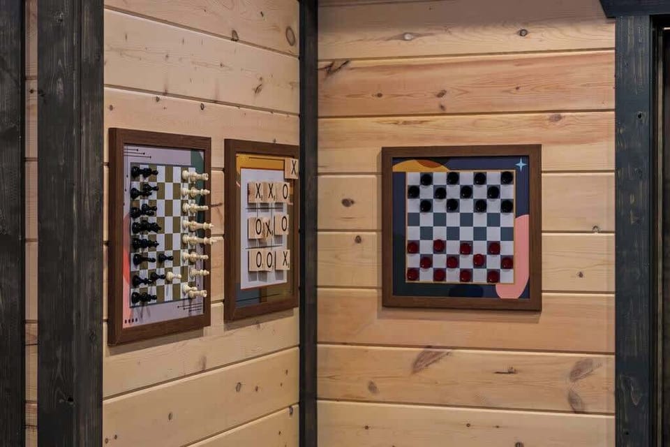 Rustic game nook with wall-mounted board games and cozy cabin charm