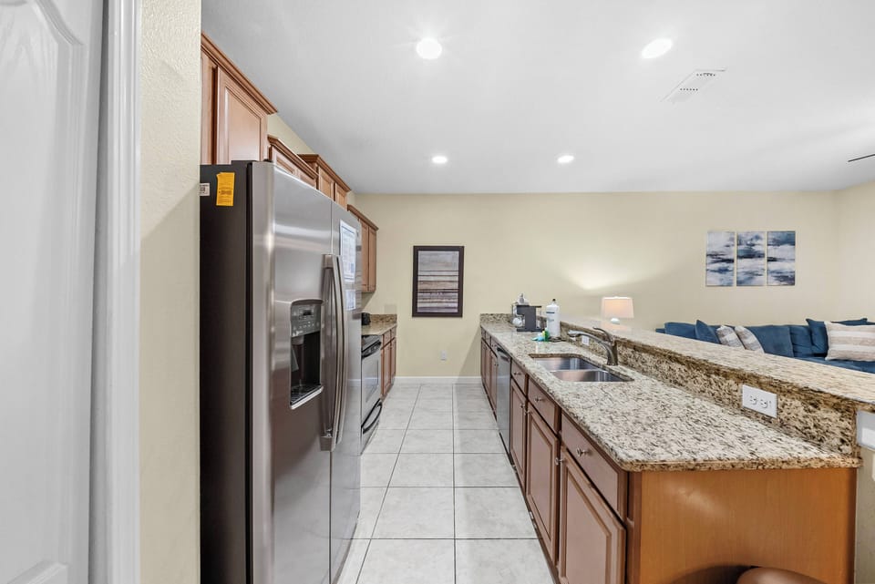 Experience a stylish kitchen with stainless steel appliances and a spacious granite countertop, perfect for culinary adventures.