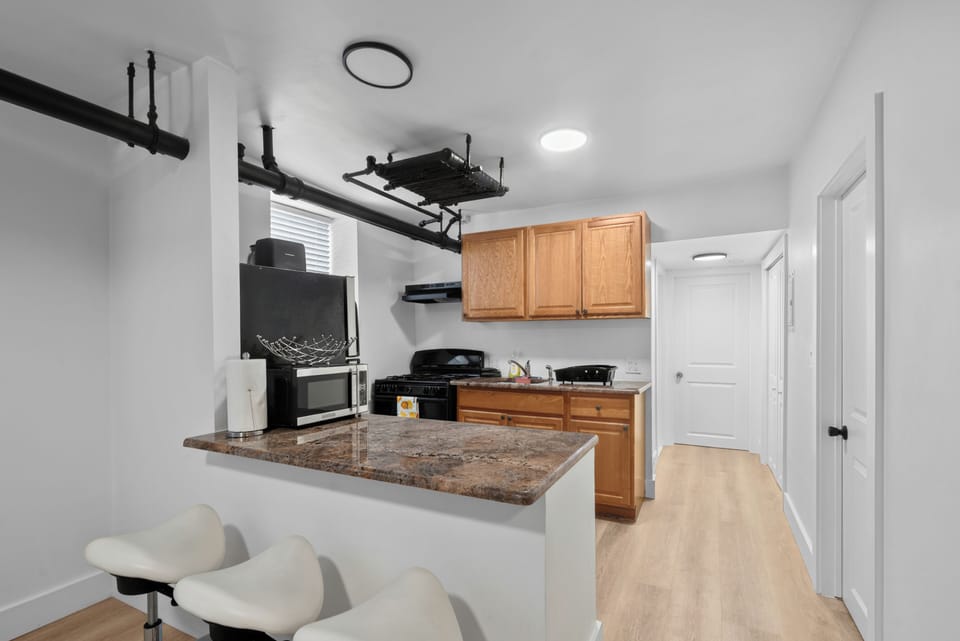 Bright kitchen with breakfast bar seating and warm wood cabinets