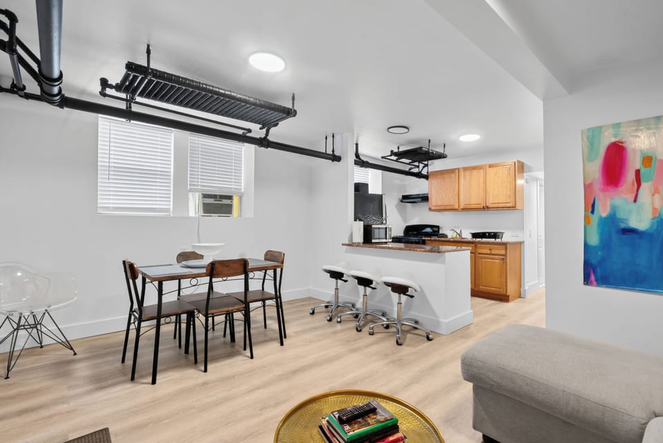 Bright open living space with dining area, breakfast bar, and stylish design
