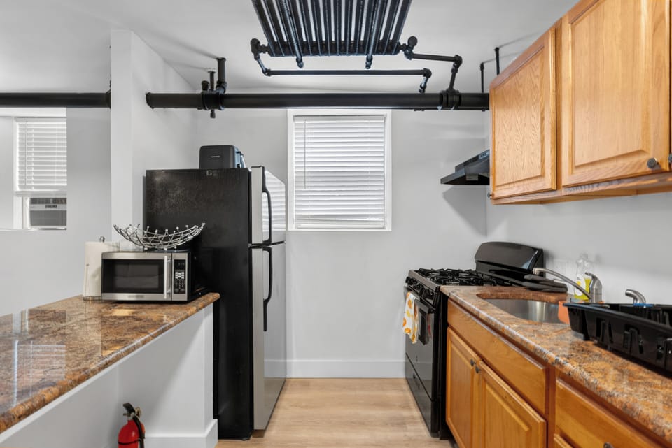 Bright industrial-style kitchen with gas stove and ample counter space