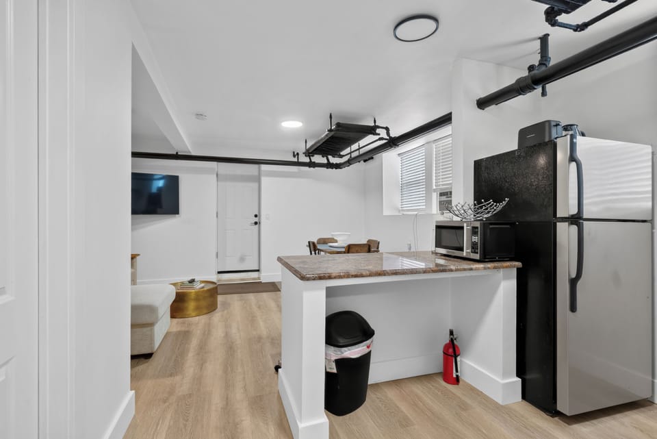 Bright modern studio with kitchenette, breakfast bar, and open living space