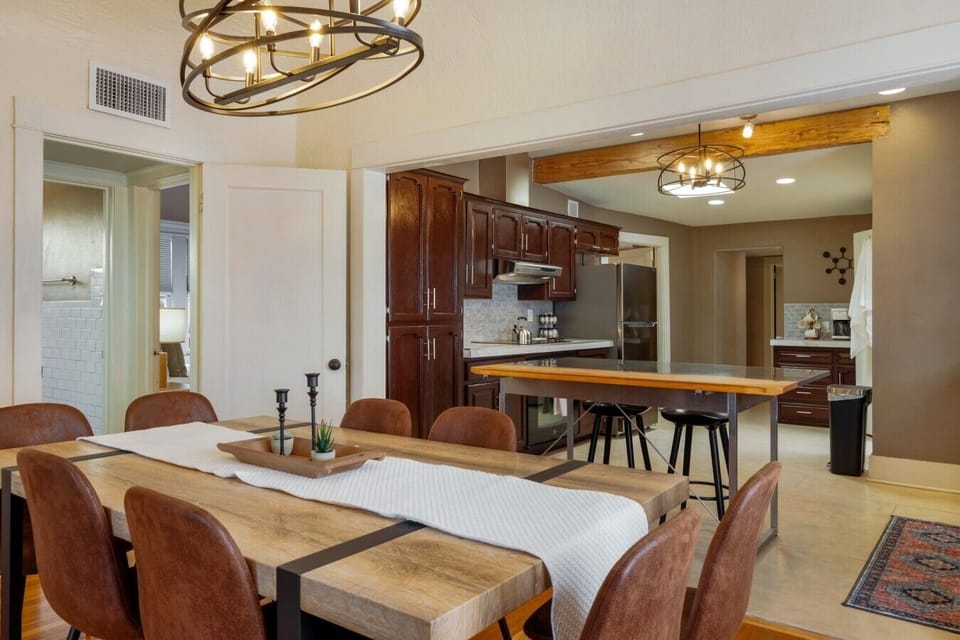 Centrally located between the kitchen and living room, the dining table seats the whole group with additional bar seating at the island
