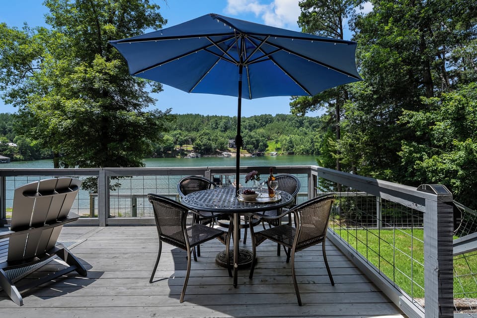 Outdoor dining with lake views from the deck.