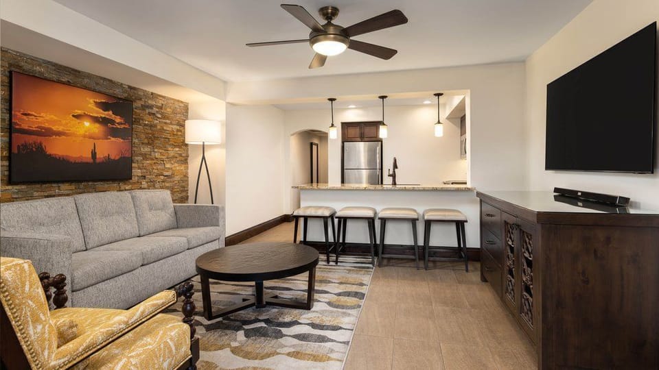Unwind in the cozy living area, where natural light plays off the stylish decor and inviting fabrics.
