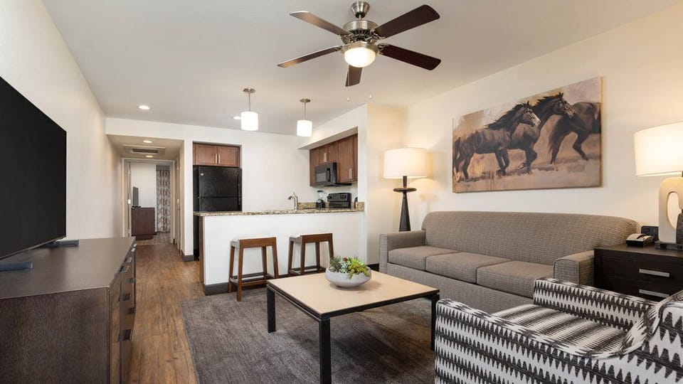 Unwind in the open living space, featuring a comfortable sofa, flat-screen TV, and inviting decor.
