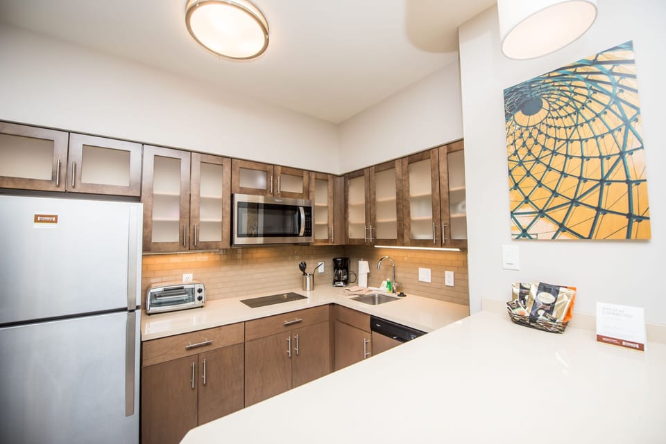 Fully equipped kitchen with refrigerator, microwave, and coffee maker.