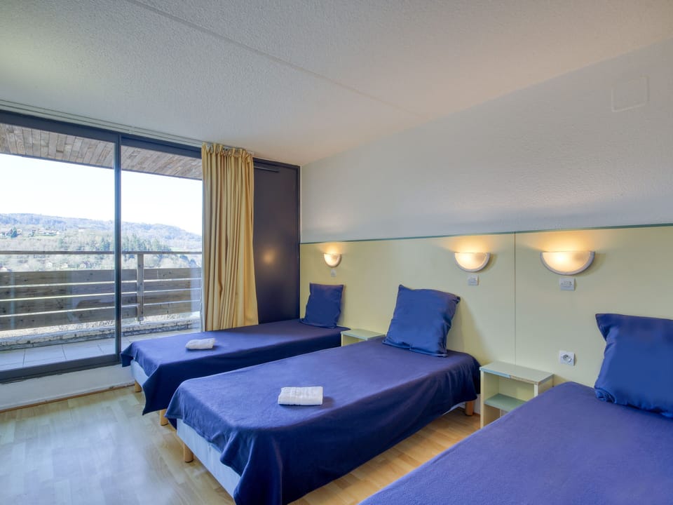 Three single beds with fresh linen — unwind after a day at the beach, just 200m away