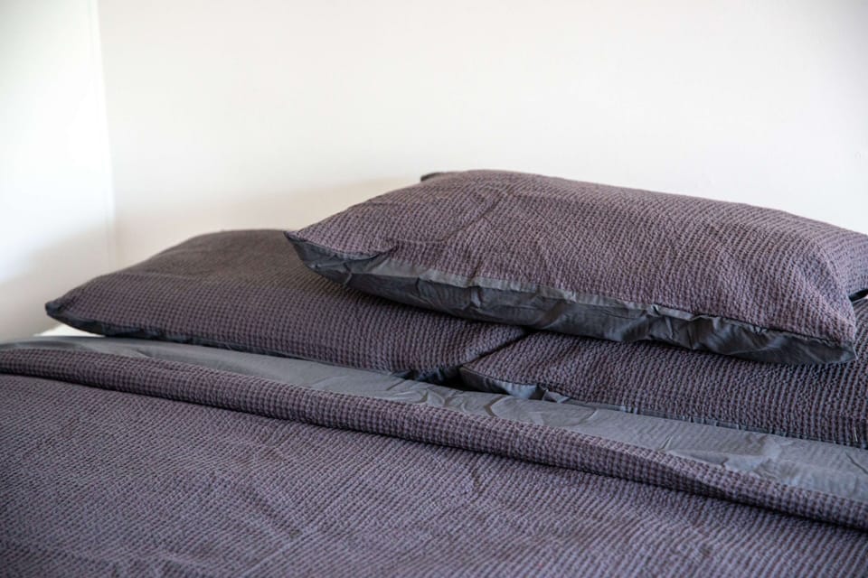 Close-up of the queen bed linens in the studio bedroom