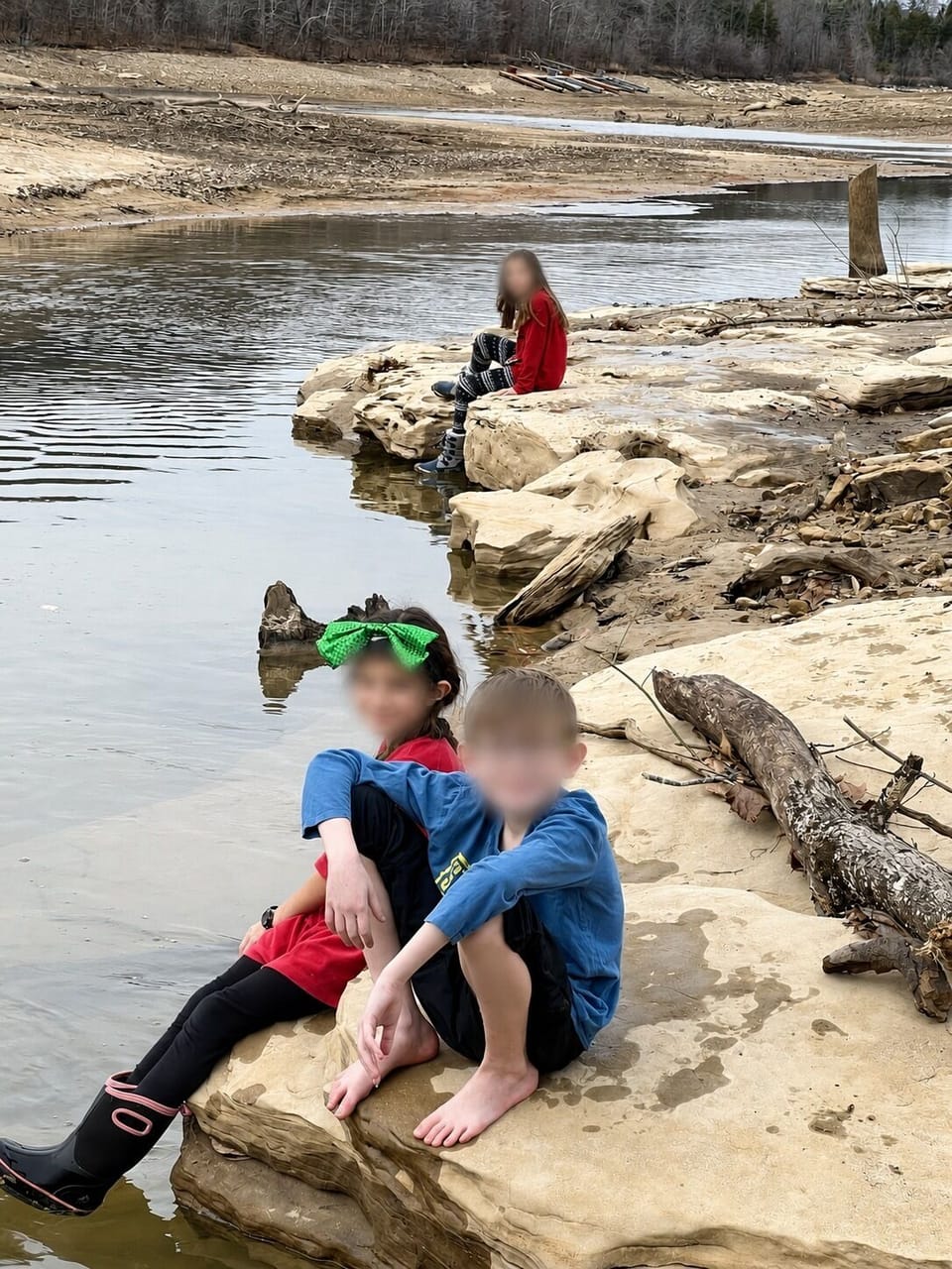 Winter-pool shoreline and creek channel; faces blurred for privacy