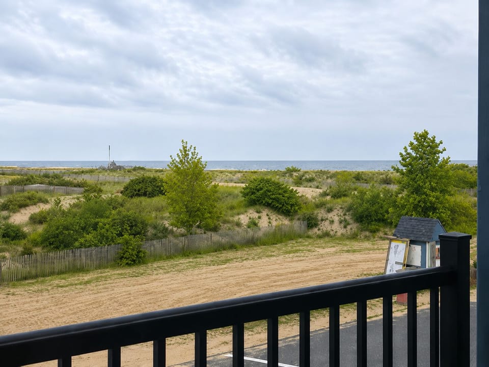 Private balcony with serene dune views and ocean beyond
