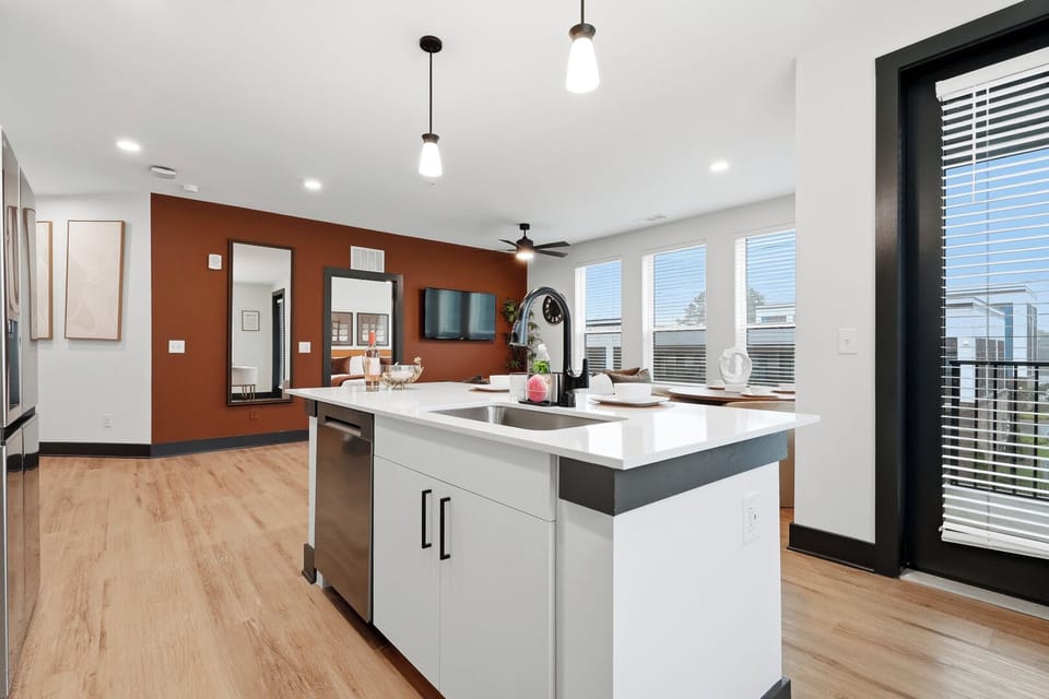 Open-concept kitchen overlooking the living and dining areas.
