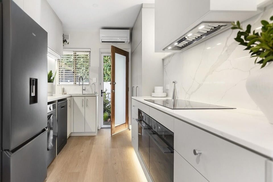 Wake refreshed in the second bedroom, where a queen bed, soft furnishings, ceiling fan, wall heater and generous built-in storage create a restful retreat.